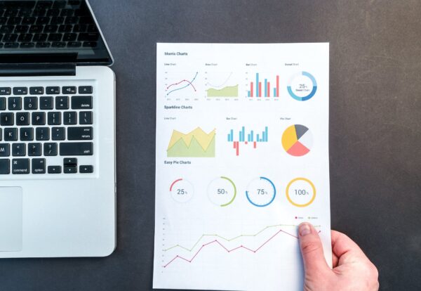 person holding chart and bar graph